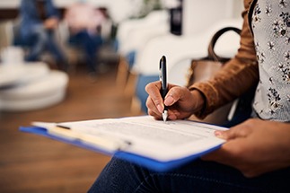 Patient filling out paperwork in lobby