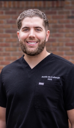 Rapid City dentist Doctor Karl Anderson smiling in black scrubs